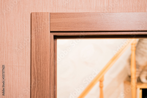 Door frame with an architrave of a brand new installed door into the bedroom with wooden staircase. Design. Style. Interior. Housing