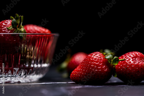 Fresh Organic Strawberries on a dark granite surface