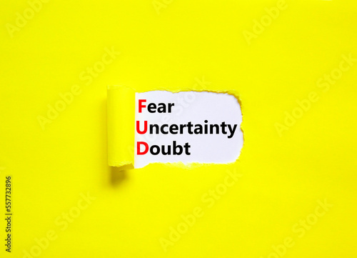 FUD fear uncertainty doubt symbol. Concept words FUD fear uncertainty doubt on white paper on a beautiful yellow background. Business and FUD fear uncertainty doubt concept. Copy space.