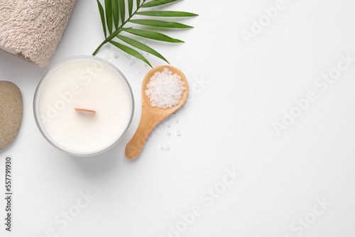 Flat lay composition with candle and different spa products on white background. Space for text