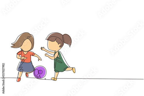 Continuous one line drawing girls playing football together. Two happy little kids playing sport at playground. Smiling children kicking ball by foot between them. Single line design vector graphic