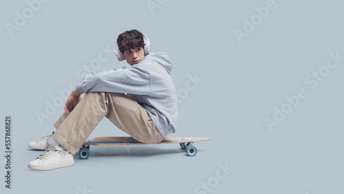 Teenager posing with a skateboard
