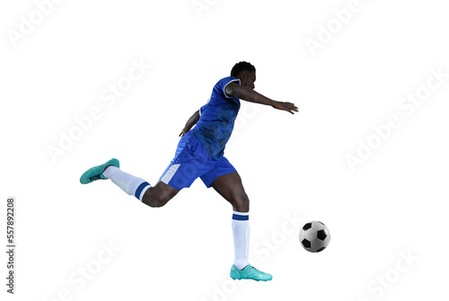Football striker with blue team suit chases the soccerball