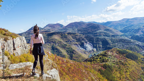 Traveler Woman standing on a rocks in the autumn mountain . Balkan mountains, ,Bulgaria