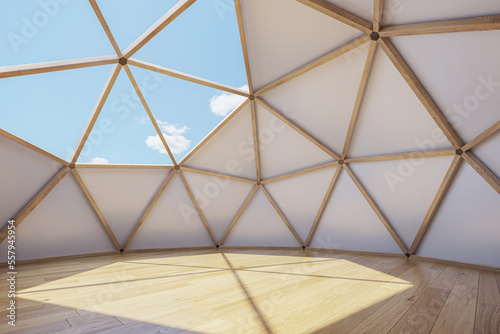 Interior of large geodesic wooden dome tent with window and view to sky. Empty interior glamping tent.