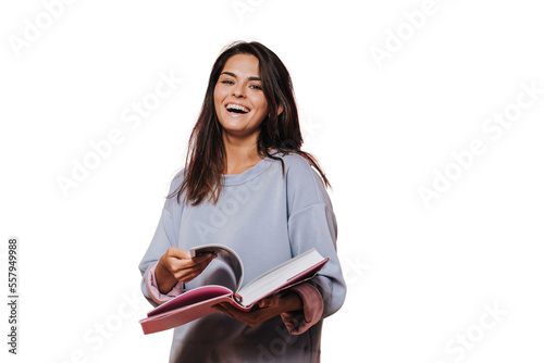 Beautiful girl in casual sweater with loose hair leafs open book on transparent background and laughing, Enjoying new book. Happy people concept. Beautiful young woman reading book. Candid emotions.
