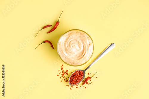 Bowl of tasty chipotle sauce on yellow background