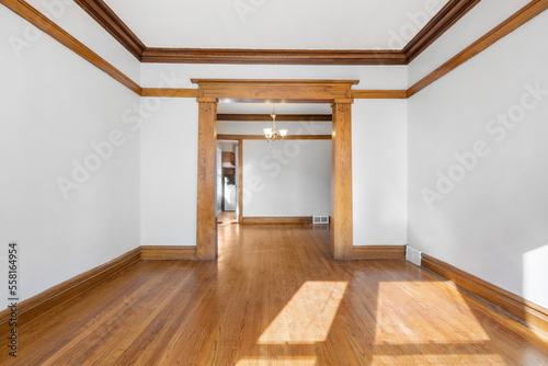 Vintage Living Room with Hardwood Floors. White walls with vintage wood trim. Empty room for virtual staging. 