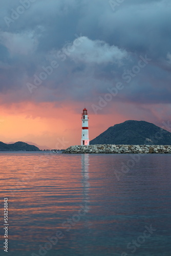 Seascape at sunshine. Lighthouse and sailings on the coast. Seaside town of Turgutreis and spectacular sunshine 