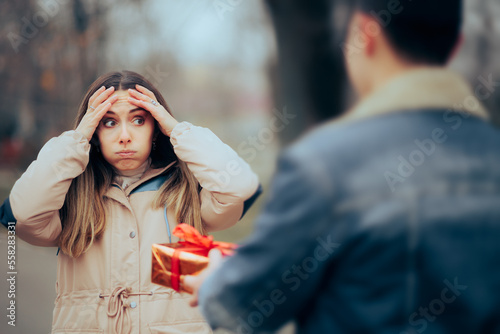 Stressed Receiving a Gift Box Forgetting their Anniversary Together. Unhappy girl stalked with presents by ex-boyfriend 