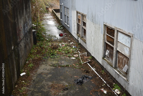 dirty alleyway behind abandoned building