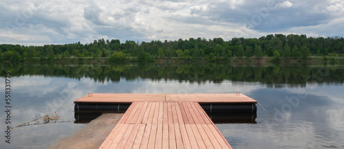 wooden pontoon footbridge at summer.