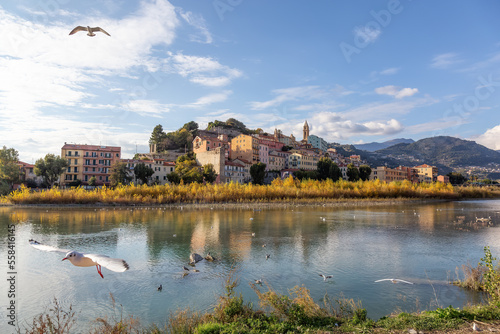 Old Residential Homes near river and sea in Ventimiglia, Italy. Sunny Fall Season.