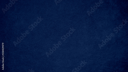 Dark blue velvet fabric texture used as background. Tone color blue cloth background of soft and smooth textile material. There is space for text and for all types of design work..