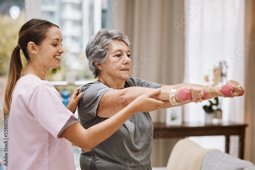Women, senior or physiotherapy help with dumbbell in wellness clinic, healthcare center or nursing home living room. Smile, happy or physiotherapist nurse and elderly patient in weight rehabilitation