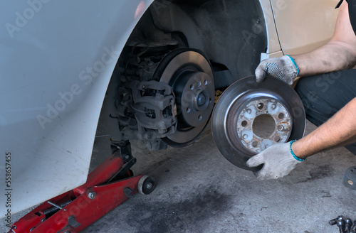 Replacing brake discs on a car. Removed the old brake disc from the car and installed the new brake disc. Car maintenance