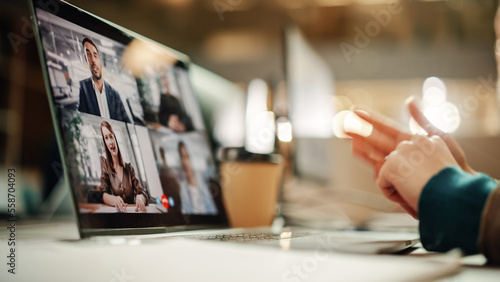 Multiethnic People Conference Meeting Online and Discussing Business Project. Laptop Screen Containing a Group Video Call. Colleagues Working From Home and Collaborating on Internet