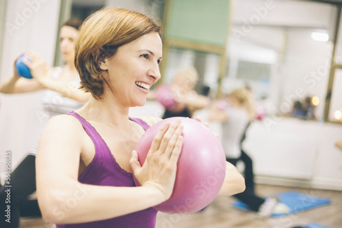 A group of women do pilates and fitness exercises for better health