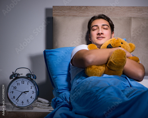 Young man sleeping in the bed