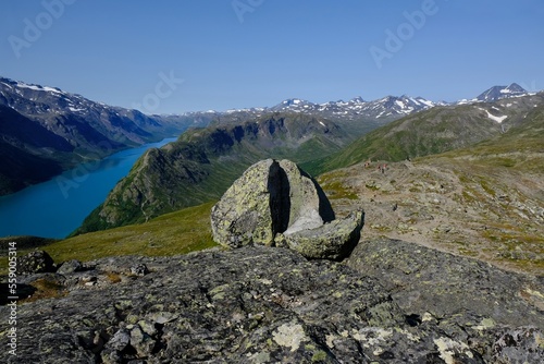 Scenic Besseggen trail with mighty boulder, in Jotunheimen, Norway - the most beautiful trekking trail in Norway