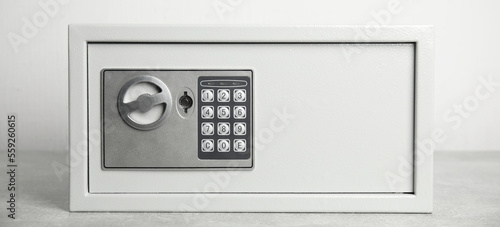 Steel safe with electronic lock on white background, banner design