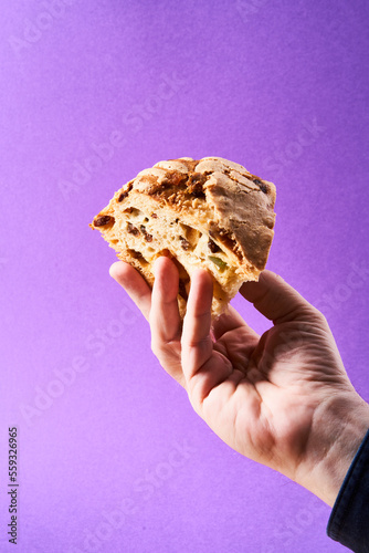 hand holding a slice of panettone