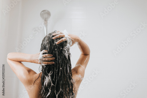 Woman washing hair with shampoo and shower in bathroom, Asian female body and hair care with foam to freshness. Spa and Health care.