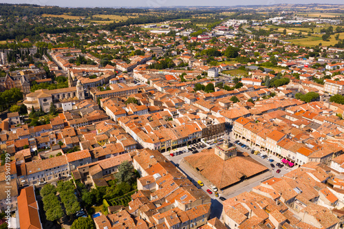 View from drone of houses of Revel town and historic covered market hall at sunny summer day, France