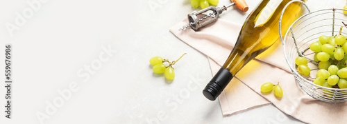 Glasses and bottle with white wine on a white background.