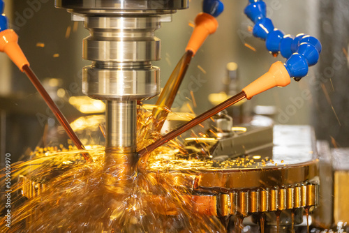 The CNC milling machine cutting the mold parts with oil coolant method.