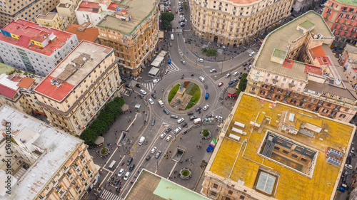 Aerial view of Giovanni Bovio square, formerly Piazza Borsa, in the historic center of Naples, Italy. In the center of the roundabout is an equestrian statue. There is the University metro stop.
