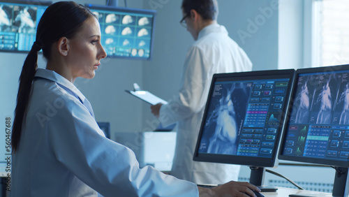 Professional medical doctors are maksing computer research in hospital office. Medicine, healthcare and cardiology concepts.