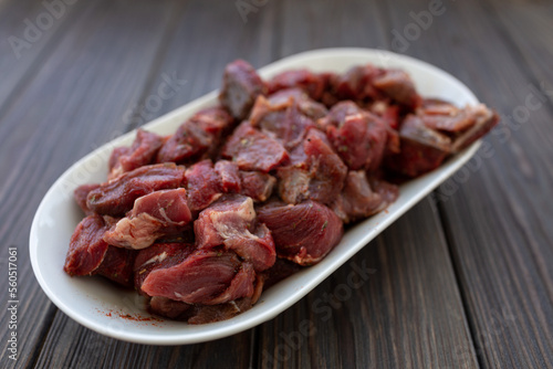 Diced and pickled raw boar meat in spices, soft focus