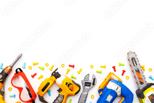 Colorful kids toy tools on white background. Flat lay. Copy space for text