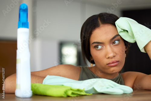 Spring cleaning, woman and sad thinking in home unhappy, bored and tired of housework service. Mental fatigue of latino maid cleaning house with frustrated, stressed and depressed face.