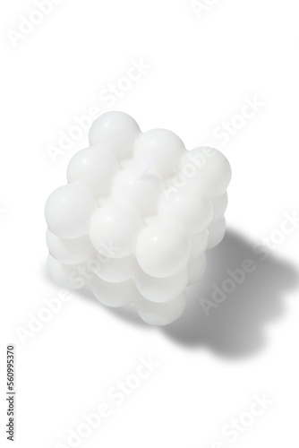 Subject shot of a figured white candle in the shape of a neocube. The designer handmade neocube candle is isolated on the white background.