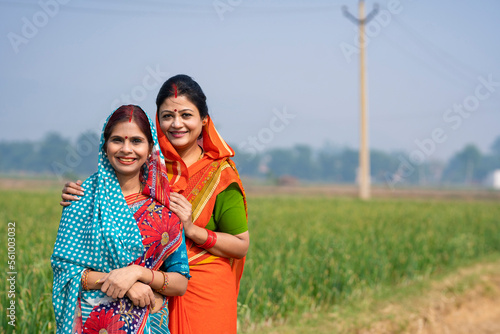 Indian rural woman’s in traditional saree at agriculture field.