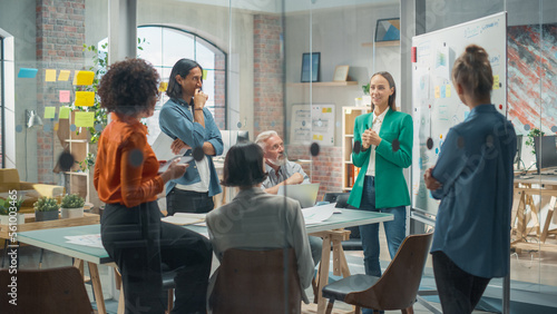 Female Business Coach for Company Management Explains How to Train your Team Efficiently in a Workshop Inside Creative Office. Woman Trainer Writing on Whiteboard and Training Interactive Employees