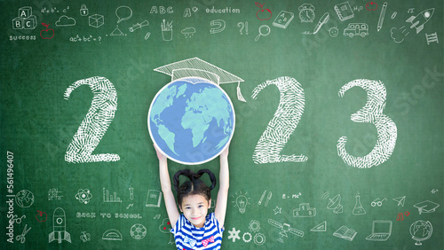 2023 new educational academic calendar year for school class with student kid raising world global planet on teacher's green chalkboard for back to school celebration, classroom schedule concept