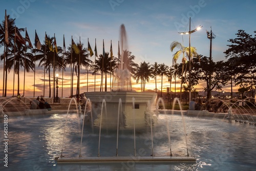 9 de Julho water fountain, Praça das Bandeiras, Gonzaga beach. City of Santos, Brazil. Sunset on the beach.