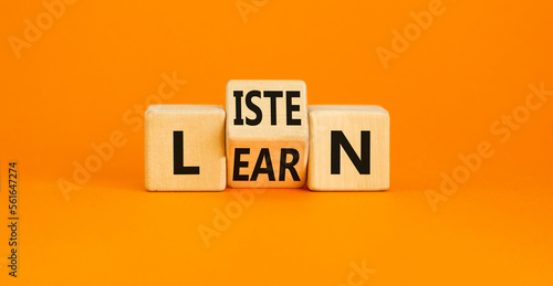 Listen and learn symbol. Concept word Listen Learn on wooden cubes. Beautiful orange table orange background. Business, education and listen and learn concept. Copy space.