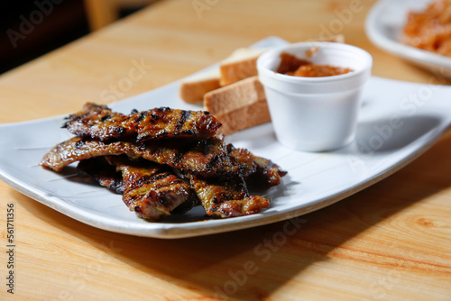 A view of a plate of pork satay.