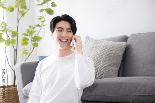 Asian male making a phone call Copy space available Smiling 