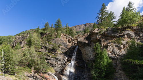 Lillaz waterfall (Cascate di Lillaz) splashes alpine water and breaks through crevice of granite rocks in Parco Nazionale Gran Paradiso, Aosta valley, Italy