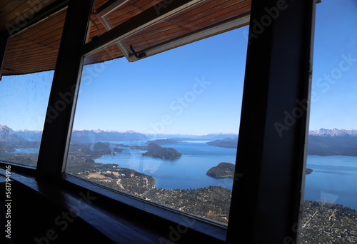  Panoramic view of Lake Nahuel Huapi from a window of the restaurant bar of the Confiteria Giratoria del Cerro Otto. Bariloche, Argentina. Patagonia. High altitude tourist attraction.