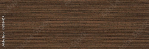 Texture of wenge wood. Dark brown wood for furniture or flooring. Close-up of a Wenge wooden plank, top view.