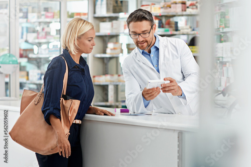 Man, pharmacist and help customer, prescription and explain instructions for medicine, vitamins and wellness. Pharmacy, female client and medical professional speaking, pills and healthcare advice