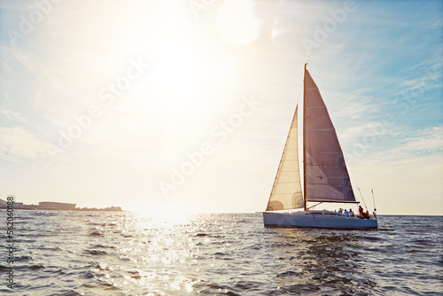 Mockup, sunset and a yacht at sea for travel, tourism or a luxury summer vacation outdoor. Blue sky, water and wave with a boat on the ocean in nature for an adventure, holiday or getaway with flare