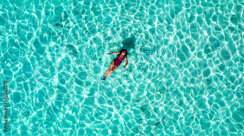 Drone Aerial of Pretty Girl Floating in Crystal Clear Blue Water at Beach In Tropical Paradise, Palawan, Philippines 1
