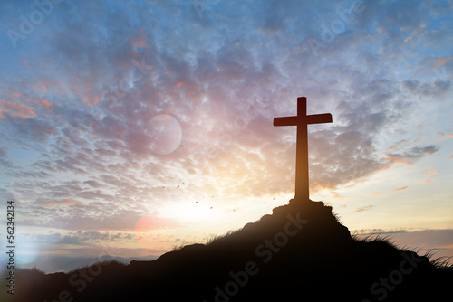 cross on blurry sunset background . 